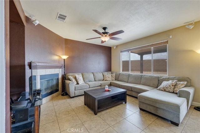 13324 Morningside St, Hesperia, CA 92344 - living area with a tile fireplace, a ceiling fan, and light tile patterned floors