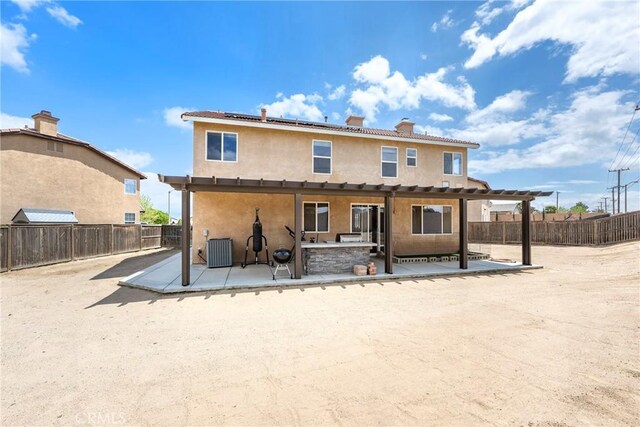 13324 Morningside St, Hesperia, CA 92344 - back of property featuring a patio, a pergola, solar panels, stucco siding, and a fenced backyard