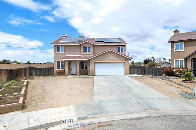 13324 Morningside St, Hesperia, CA 92344 - traditional home with a tile roof, stucco siding, a garden, concrete driveway, and roof mounted solar panels