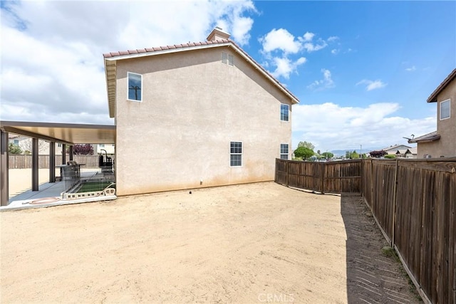 13324 Morningside St, Hesperia, CA 92344 - rear view of house with stucco siding, a patio area, and a fenced backyard