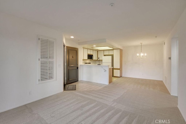 2800 Keller Dr Unit 282, Tustin, CA 92782 - unfurnished living room featuring a chandelier, light carpet, and recessed lighting