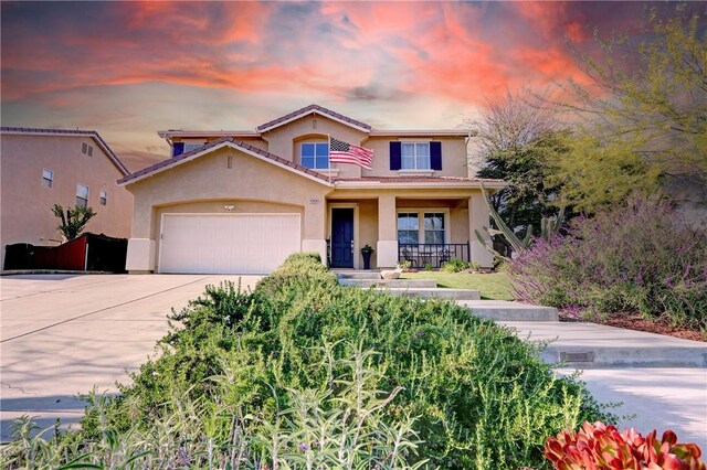 19068 Sunflower Pl, Riverside, CA 92508 - mediterranean / spanish-style home featuring a porch, driveway, stucco siding, an attached garage, and a tiled roof