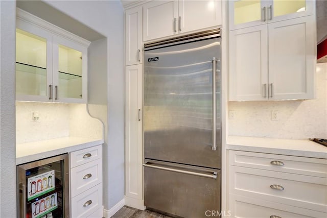 19068 Sunflower Pl, Riverside, CA 92508 - kitchen with built in refrigerator, wine cooler, light countertops, and white cabinetry
