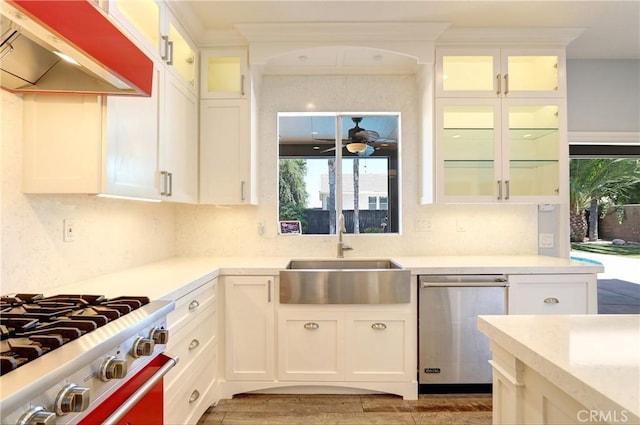 19068 Sunflower Pl, Riverside, CA 92508 - kitchen with extractor fan, stainless steel dishwasher, light countertops, range, and white cabinetry