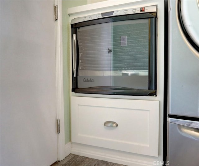 19068 Sunflower Pl, Riverside, CA 92508 - detailed view of wall oven, white cabinets, and dark countertops
