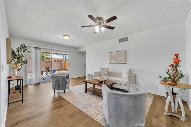 45121 17th St W, Lancaster, CA 93534 - living area with a textured ceiling, a ceiling fan, and light wood-type flooring