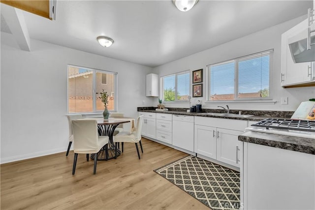 45121 17th St W, Lancaster, CA 93534 - kitchen with dishwasher, dark countertops, light wood finished floors, and white cabinetry