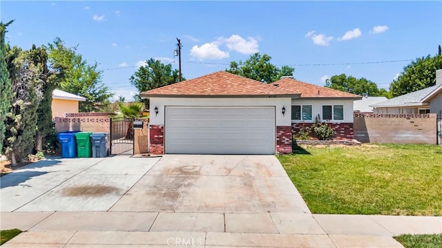 45121 17th St W, Lancaster, CA 93534 - ranch-style house with stucco siding, a gate, an attached garage, concrete driveway, and brick siding