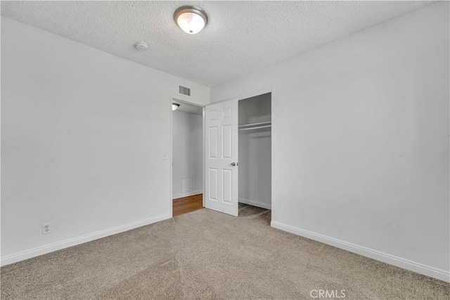 45121 17th St W, Lancaster, CA 93534 - unfurnished bedroom with carpet flooring, a textured ceiling, and a closet