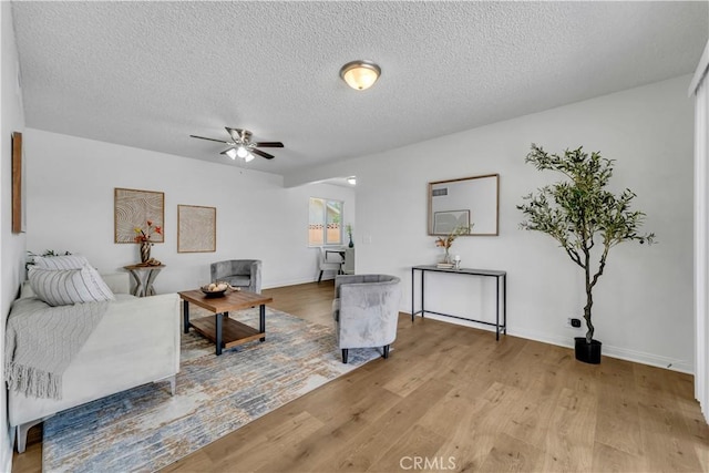45121 17th St W, Lancaster, CA 93534 - living room with a ceiling fan, light wood finished floors, and a textured ceiling