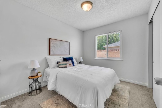 45121 17th St W, Lancaster, CA 93534 - carpeted bedroom with a textured ceiling and baseboards