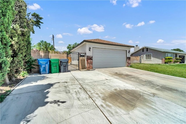 45121 17th St W, Lancaster, CA 93534 - single story home with a gate, brick siding, concrete driveway, and stucco siding