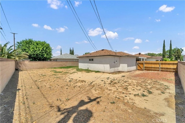 45121 17th St W, Lancaster, CA 93534 - rear view of property featuring a fenced backyard and stucco siding