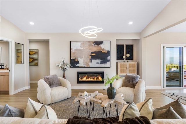 29805 Knoll View Dr, Rancho Palos Verdes, CA 90275 - living room with light wood-style floors, a glass covered fireplace, a chandelier, and recessed lighting