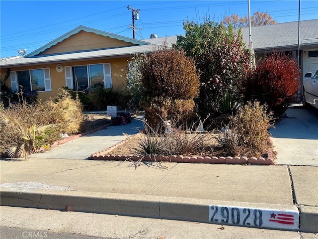 29028 Pebble Beach Dr, Menifee, CA 92586 - view of front of home featuring stucco siding