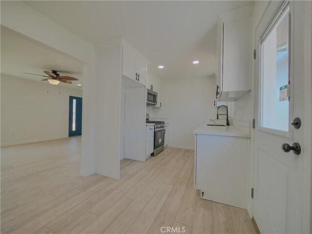 24931 Vine St, San Bernardino, CA 92410 - kitchen with stainless steel appliances, light countertops, a ceiling fan, light wood-style floors, and recessed lighting