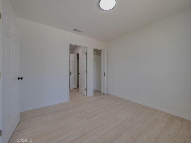 24931 Vine St, San Bernardino, CA 92410 - unfurnished bedroom with light wood finished floors and a closet