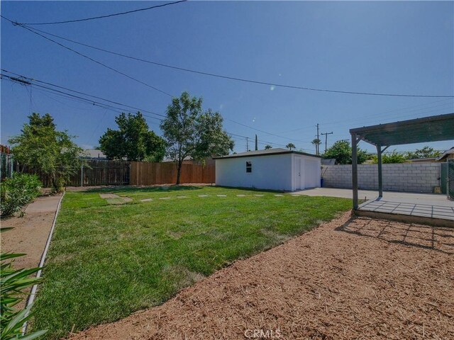 24931 Vine St, San Bernardino, CA 92410 - fenced backyard featuring a patio area and an outdoor structure