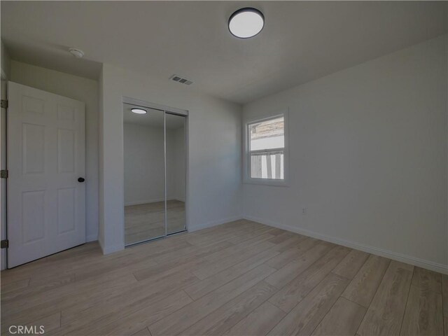 24931 Vine St, San Bernardino, CA 92410 - unfurnished bedroom featuring light wood-type flooring and a closet
