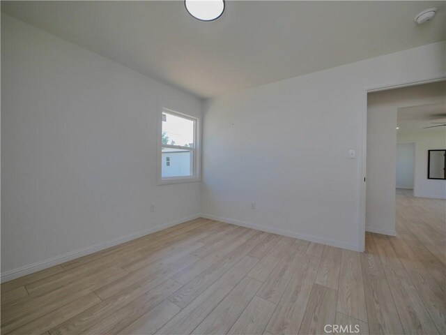 24931 Vine St, San Bernardino, CA 92410 - unfurnished room with light wood-style flooring and a smoke detector