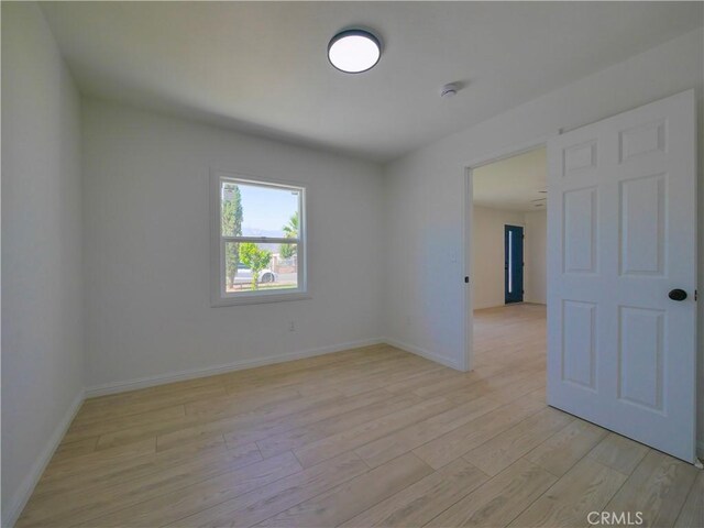 24931 Vine St, San Bernardino, CA 92410 - spare room featuring light wood-style flooring and a smoke detector