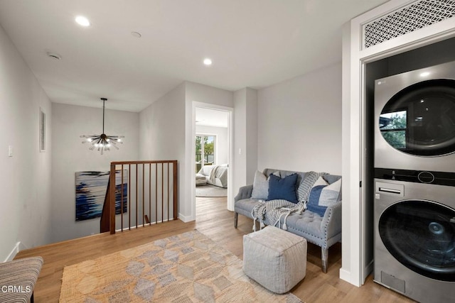 845 Rollin St, South Pasadena, CA 91030 - washroom with stacked washer and clothes dryer, light wood-style floors, and recessed lighting