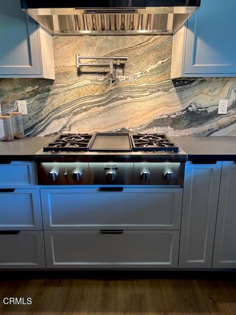 845 Rollin St, South Pasadena, CA 91030 - detailed view of decorative backsplash, pot filler, stainless steel gas stovetop, and dark wood finished floors