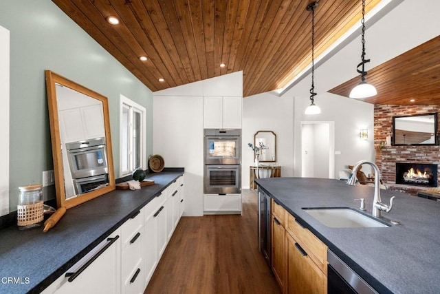 845 Rollin St, South Pasadena, CA 91030 - kitchen with double oven, wood ceiling, dark countertops, dark wood-style flooring, and pendant lighting