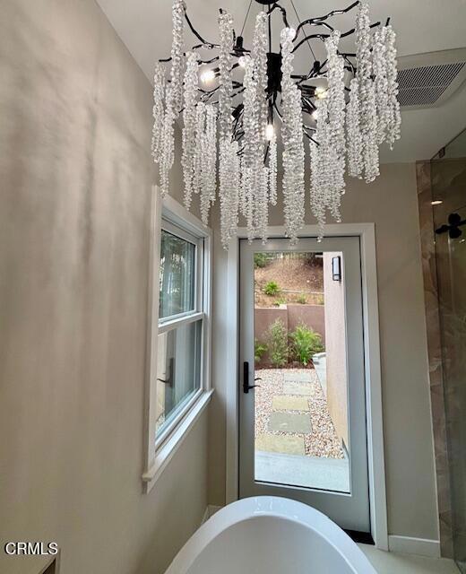 845 Rollin St, South Pasadena, CA 91030 - detailed view of a soaking tub, a chandelier, and tiled shower