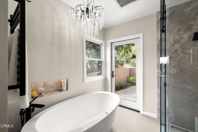 845 Rollin St, South Pasadena, CA 91030 - bathroom featuring a freestanding bath, a chandelier, tile patterned flooring, and a shower stall