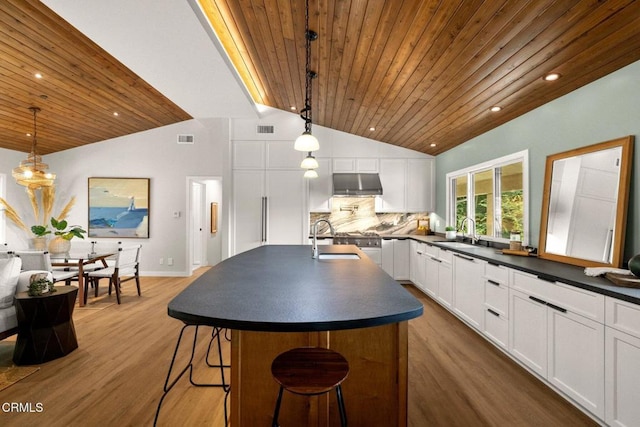 845 Rollin St, South Pasadena, CA 91030 - kitchen featuring dark countertops, under cabinet range hood, wood ceiling, vaulted ceiling, and decorative backsplash