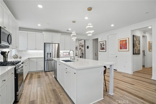 28410 Orange Park Dr, Castaic, CA 91384 - kitchen featuring appliances with stainless steel finishes, light wood finished floors, recessed lighting, light countertops, and white cabinets