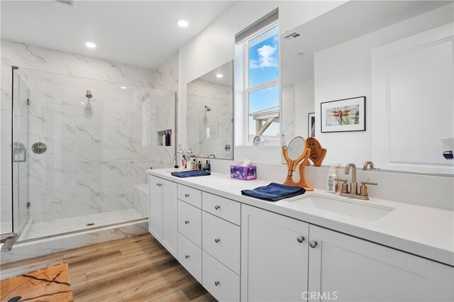 28410 Orange Park Dr, Castaic, CA 91384 - full bathroom featuring a marble finish shower, double vanity, recessed lighting, and wood finished floors