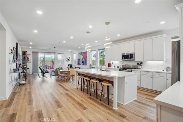 28410 Orange Park Dr, Castaic, CA 91384 - kitchen featuring appliances with stainless steel finishes, light countertops, light wood-type flooring, plenty of natural light, and recessed lighting