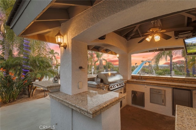 1042 Coronet Dr, Riverside, CA 92506 - view of patio featuring exterior kitchen and a ceiling fan