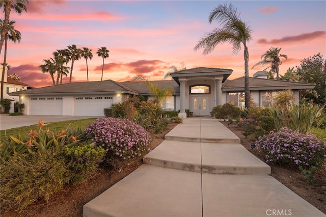 1042 Coronet Dr, Riverside, CA 92506 - view of front of home with driveway, stucco siding, and a garage