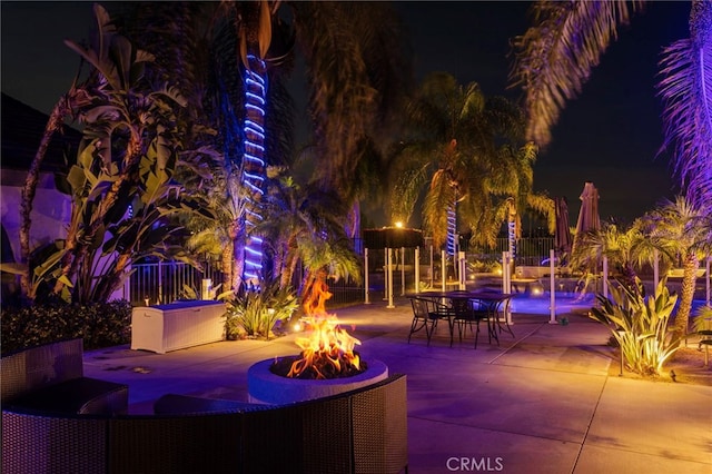 1042 Coronet Dr, Riverside, CA 92506 - patio at night with a fire pit and a patio