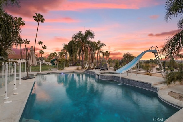 1042 Coronet Dr, Riverside, CA 92506 - view of swimming pool with a water slide and a pool with connected hot tub