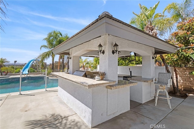 1042 Coronet Dr, Riverside, CA 92506 - fenced backyard with exterior kitchen, a gazebo, and a patio area