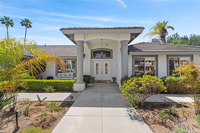 1042 Coronet Dr, Riverside, CA 92506 - doorway to property with a tiled roof, a porch, stucco siding, and french doors