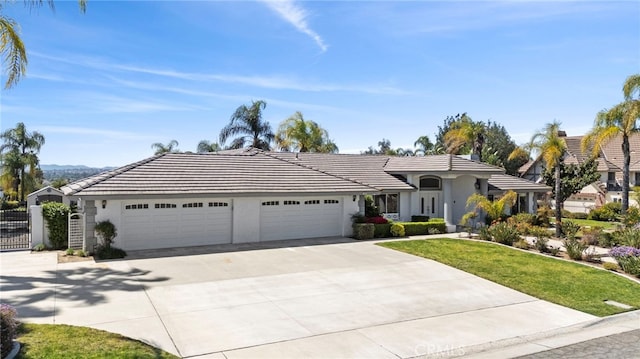 1042 Coronet Dr, Riverside, CA 92506 - single story home with concrete driveway, a garage, stucco siding, and a tiled roof