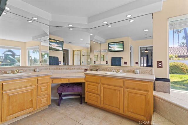 1042 Coronet Dr, Riverside, CA 92506 - full bathroom with recessed lighting, double vanity, tile patterned floors, and a stall shower