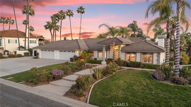 1042 Coronet Dr, Riverside, CA 92506 - view of front of property featuring driveway, a garage, a front lawn, a tile roof, and stucco siding