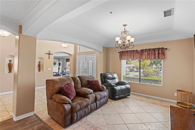 1042 Coronet Dr, Riverside, CA 92506 - living area featuring arched walkways, a chandelier, light tile patterned flooring, and crown molding