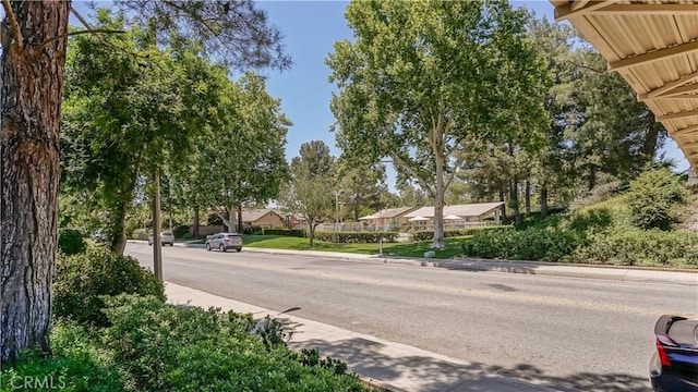 26010 Coronado Ct, Valencia, CA 91355 - view of asphalt street with curbs, sidewalks, and street lighting