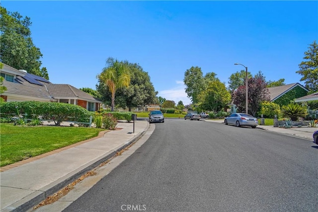 26010 Coronado Ct, Valencia, CA 91355 - view of asphalt road with sidewalks, curbs, and street lights