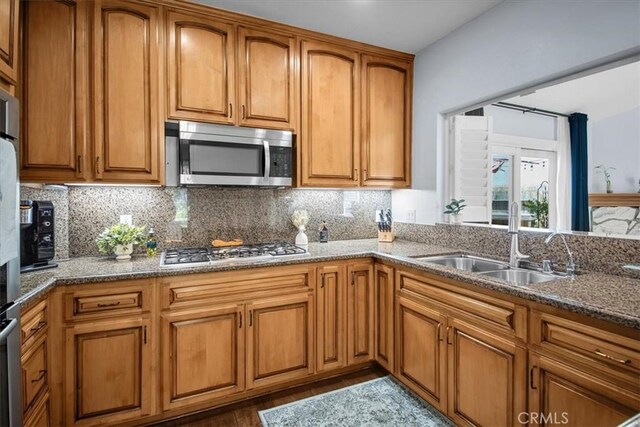 26010 Coronado Ct, Valencia, CA 91355 - kitchen featuring stainless steel appliances, brown cabinets, and tasteful backsplash