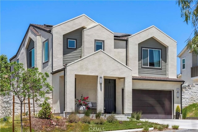 27774 Marquee Dr, Valencia, CA 91381 - view of front of property with an attached garage, roof mounted solar panels, stucco siding, and driveway