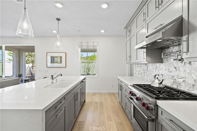 27774 Marquee Dr, Valencia, CA 91381 - kitchen featuring appliances with stainless steel finishes, under cabinet range hood, gray cabinets, healthy amount of natural light, and recessed lighting