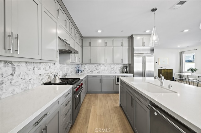 27774 Marquee Dr, Valencia, CA 91381 - kitchen featuring premium appliances, gray cabinetry, under cabinet range hood, light countertops, and recessed lighting